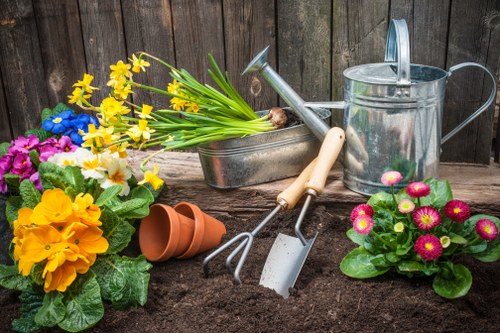 Gardener finishing a tidy-up at a maisonette rear garden